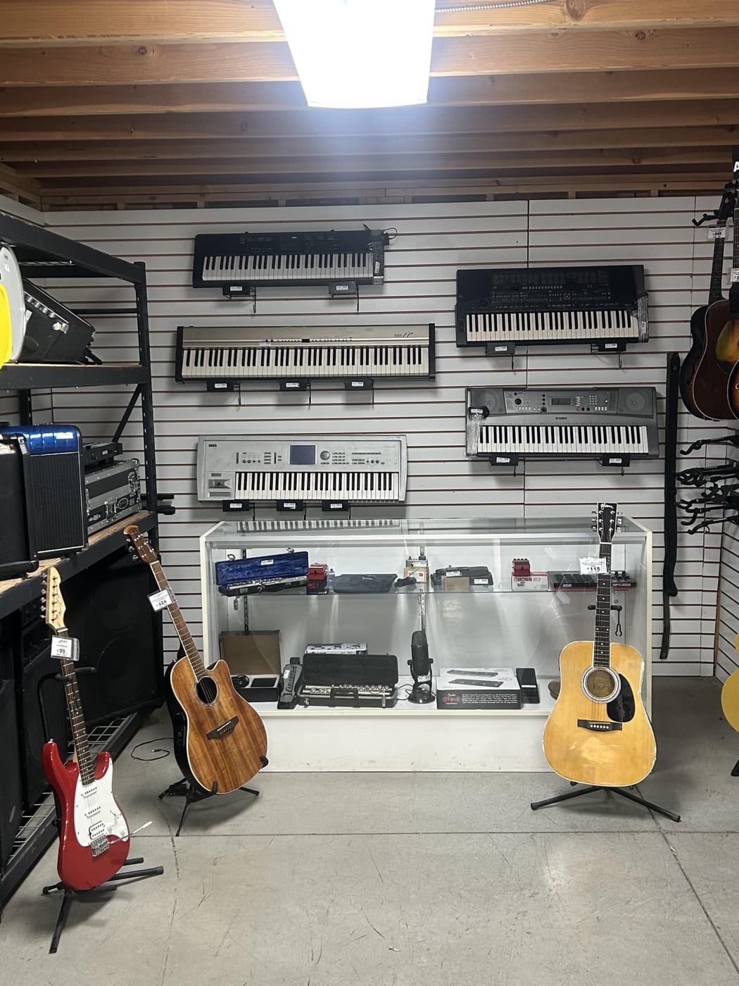 Keyboards and guitars displayed inside Cash 1 Pawn in Missoula
